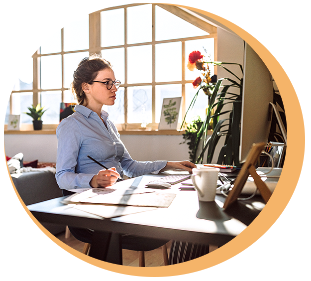 Woman sitting at desk looking at computer